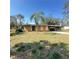 Single story home with a light-colored exterior, driveway, dead yard, and a palm tree at 4384 Frances Ave, Sanford, FL 32773