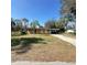 Single story home with a light-colored exterior, driveway, dead yard, and a palm tree at 4384 Frances Ave, Sanford, FL 32773