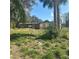 Exterior of the house is visible with overgrown grass; there is an opened shed on the property at 4384 Frances Ave, Sanford, FL 32773