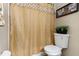 Bathroom featuring a toilet, a shower with gold curtain, and a framed print at 4515 Sea Biscut Ct, Orlando, FL 32818