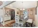 Elegant dining room featuring a farmhouse table, chandelier lighting, and a decorative accent wall for a warm ambiance at 4515 Sea Biscut Ct, Orlando, FL 32818