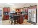 A well-equipped kitchen features a center island, dark wood cabinets, and stainless steel appliances at 4515 Sea Biscut Ct, Orlando, FL 32818