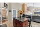 A kitchen featuring a center island with seating, granite countertops, and ample cabinet space at 4515 Sea Biscut Ct, Orlando, FL 32818