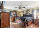 Elegant main bedroom featuring hardwood floors, ornate furnishings, a ceiling fan, and ample natural light at 4515 Sea Biscut Ct, Orlando, FL 32818