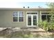 Back exterior view of home featuring a patio area and views of the well-maintained lawn at 500 Pickfair Ter, Lake Mary, FL 32746