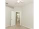 A bright, carpeted bedroom with white walls, ceiling fan, and an ensuite bathroom entrance at 500 Pickfair Ter, Lake Mary, FL 32746