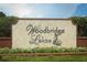 Stone entrance sign with brick accents identifying the Woodbridge Lakes community at 500 Pickfair Ter, Lake Mary, FL 32746