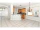 Open kitchen area with granite countertops and wooden cabinetry at 500 Pickfair Ter, Lake Mary, FL 32746