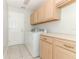 Featuring a washer and dryer, cabinets, and a utility sink at 500 Pickfair Ter, Lake Mary, FL 32746