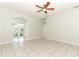 Bright and airy living room featuring tile flooring, ceiling fan, and views to the sunroom and backyard at 500 Pickfair Ter, Lake Mary, FL 32746