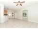 Open living room area features tile floors, ceiling fan, and views into the dining area at 500 Pickfair Ter, Lake Mary, FL 32746