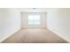 This is an empty room with wall-to-wall carpeting and bright natural light at 5030 Tibet Ct, St Cloud, FL 34772