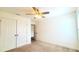 Bright bedroom with neutral carpet, a ceiling fan, and closet storage space at 5030 Tibet Ct, St Cloud, FL 34772