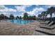 Community pool with lounge chairs, umbrellas, and play structures at 5030 Tibet Ct, St Cloud, FL 34772