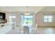 Open concept dining room with water view and modern chandelier at 5030 Tibet Ct, St Cloud, FL 34772