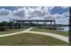 Community lakeside dock and gazebo with swing benches and walking path at 5030 Tibet Ct, St Cloud, FL 34772