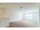 The loft area is carpeted and bright with a large window at 5030 Tibet Ct, St Cloud, FL 34772