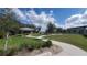 Scenic view of the park featuring a walking path, picnic tables, and lush greenery at 5030 Tibet Ct, St Cloud, FL 34772