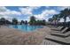 Community pool area with lounge chairs, a splash pad, and lush tropical landscaping on a sunny day at 5030 Tibet Ct, St Cloud, FL 34772