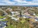 An aerial view showcases homes nestled near a beautiful lake under a partly cloudy sky, highlighting the serene location at 513 Wisconsin Ave, St Cloud, FL 34769