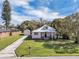 Exterior angle features charming single-story home with detached garage, showcasing a well-manicured lawn and inviting curb appeal at 513 Wisconsin Ave, St Cloud, FL 34769