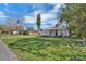 Quaint home featuring a well-maintained lawn, mature trees, and inviting front porch at 513 Wisconsin Ave, St Cloud, FL 34769