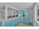 Bright kitchen with light blue cabinets and a view into the dining area, offering a cheerful space at 513 Wisconsin Ave, St Cloud, FL 34769