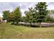 Green backyard with a view of a tranquil waterway lined with trees at 5521 Rutherford Pl, Oviedo, FL 32765