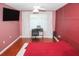 Bedroom with desk, television, neutral colored walls, and hardwood floors at 5521 Rutherford Pl, Oviedo, FL 32765