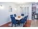 Dining room featuring wood floors, a modern light fixture, and blue velvet chairs at 5521 Rutherford Pl, Oviedo, FL 32765