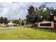 Elegant community entrance with brick signage and manicured landscaping at 5521 Rutherford Pl, Oviedo, FL 32765