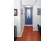 Hallway with wood floors and a blue accent wall that features three framed pictures at 5521 Rutherford Pl, Oviedo, FL 32765