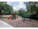 Community playground featuring slides and a unique climbing structure at 5521 Rutherford Pl, Oviedo, FL 32765