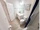 Clean bathroom featuring a tub, shower, white vanity, framed artwork, and wood-look tile flooring at 6004 Oak Green Loop, Davenport, FL 33837