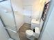 Well-lit bathroom with glass shower doors, white vanity, framed art, and sleek fixtures at 6004 Oak Green Loop, Davenport, FL 33837