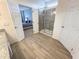 This bathroom features a glass-enclosed shower and doorway to the bedroom at 6004 Oak Green Loop, Davenport, FL 33837