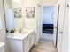 Bathroom with a view into bedroom featuring a white vanity with a sink and a gray-themed bedroom set at 6004 Oak Green Loop, Davenport, FL 33837