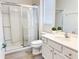 Bathroom features a white vanity with sink, toilet, and a glass-enclosed shower at 6004 Oak Green Loop, Davenport, FL 33837