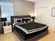 Bedroom featuring a black and white bed, gray walls, a window with blinds, and a double door closet at 6004 Oak Green Loop, Davenport, FL 33837