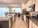 Bright, open kitchen featuring granite countertops, modern appliances, and an adjacent dining area at 6004 Oak Green Loop, Davenport, FL 33837