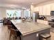 Gourmet kitchen featuring a large island with bar seating, modern lighting, and stainless steel appliances at 6004 Oak Green Loop, Davenport, FL 33837