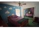 Cheerful bedroom with playful cloud-themed walls, natural light, and ceiling fan at 6250 S Bend Sq # 17, Orlando, FL 32807