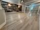 Spacious bedroom featuring laminate floors, accent wall, ceiling fan, and mirrored closet doors at 6725 Sawmill Blvd, Ocoee, FL 34761