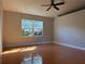 Bright bedroom with tile flooring, ceiling fan and natural light from window at 6725 Sawmill Blvd, Ocoee, FL 34761