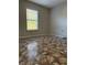 Bright bedroom featuring a window with tile flooring at 6725 Sawmill Blvd, Ocoee, FL 34761