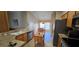 Galley-style kitchen with stainless steel appliances, plenty of counter space, and an adjacent dining area at 687 Andover Cir, Winter Springs, FL 32708