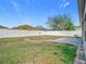 View of a large backyard featuring a white fence and brick-paved patio area at 7214 Rex Hill Trl, Orlando, FL 32818