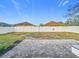 Spacious backyard featuring a white fence and brick-paved patio area at 7214 Rex Hill Trl, Orlando, FL 32818