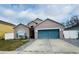 Charming single Gathering home with large garage and manicured front yard with blue shutters and blue garage door at 7214 Rex Hill Trl, Orlando, FL 32818