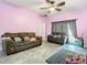 Open living room with a ceiling fan and sliding door access at 7214 Rex Hill Trl, Orlando, FL 32818